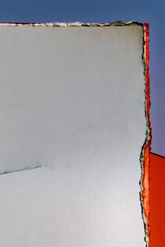 Creased and reflattened paper proof with torn edges and offset ink, propped against a blue window for album artwork and poster backgrounds