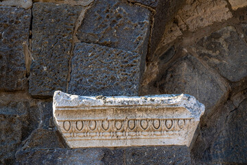Ancient Carved Marble Cornice Fragment Embedded into Historic Stone Wall © fencifd