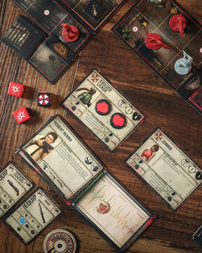 Resident Evil 2 board game components close up featuring zombie miniatures survival horror cards game board custom dice and box cinematic dramatic lighting tabletop game layout for hobby recreation