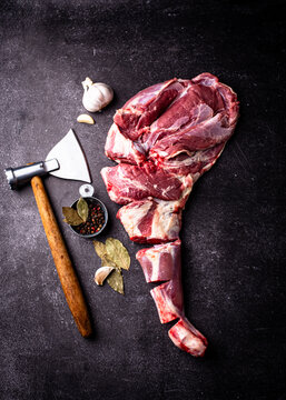 Raw leg of lamb ready to cook. Fresh farm meat on dark background