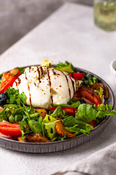 Delicious salad with burrata cheese grilled peaches and blueberry