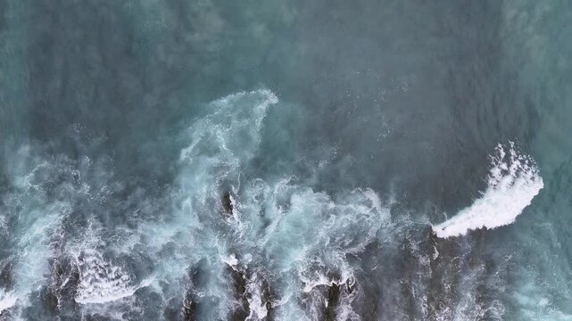 Aerial view of ocean waves crashing against rocks at Manzanillo Beach, Costa Rica