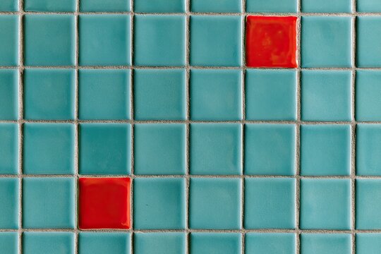 Teal square tiles with a repeating grid pattern, accented by red squares
