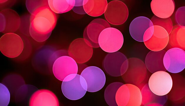 Soft, out-of-focus red and purple circles glow against a dark background