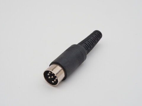 9-pin Mini-DIN Connector - A close-up shot of a black 9-pin mini-DIN connector with a metallic tip and a flexible cable strain relief, isolated on a white background.