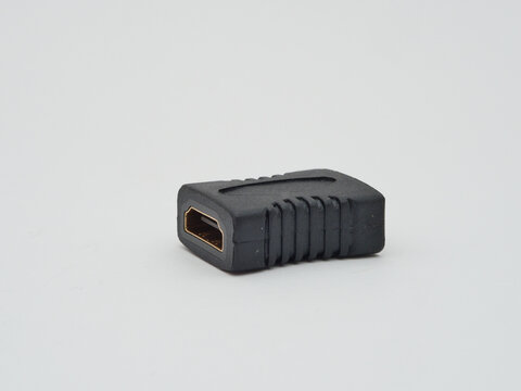 HDMI Adapter Coupler on White Background - A black HDMI adapter coupler with a gold-plated connector is isolated on a clean white background, ready for technology connection.