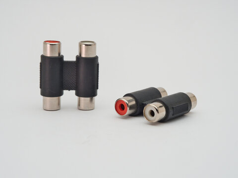 RCA Female to Female Audio Couplers - Two black RCA female to female audio barrel connectors, also known as couplers or adapters, on a clean white background.