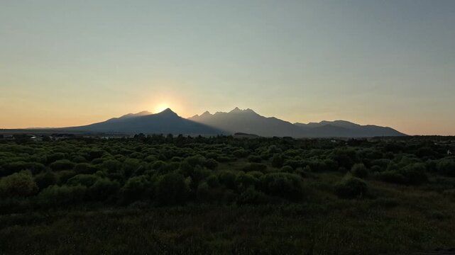 lomnicky stit peak sunset high tatras mountains golden sun rays green forest valley slovakia landscape timelapse concept of travel, nature, tourism