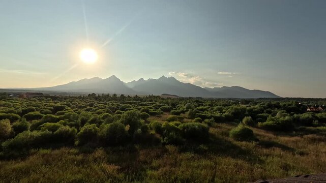 lomnicky stit peak sunset high tatras mountains golden sun rays green forest valley slovakia landscape timelapse concept of travel, nature, tourism