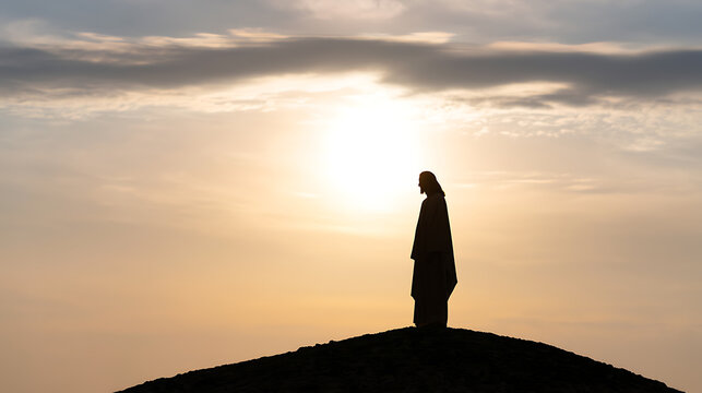 Silhouette of a robed figure standing alone on a hilltop at sunrise, evoking a sense of deep spiritual connection, peace, and divine grace