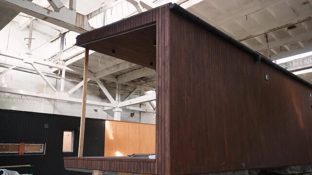 Modular wooden house construction inside warehouse