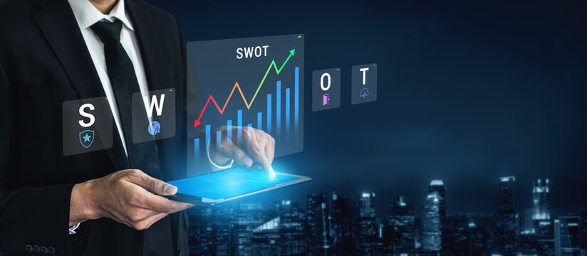 A businessman uses a tablet to analyze data, showcasing a SWOT analysis and growth chart. The urban skyline at night offers a professional backdrop for modern business insights. Nascent