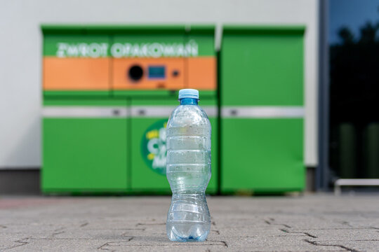 Beverage bottles in front of a packaging return station.