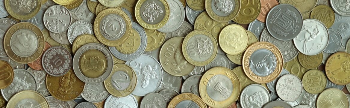 Big pile of coins from different money currencies. Treasure and numismatics concept