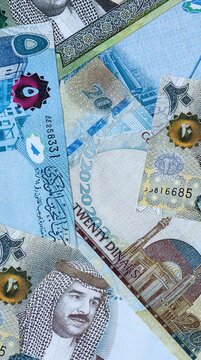 Bahraini dinar money bills in pile on table. Bahrain BHD currency cash close up