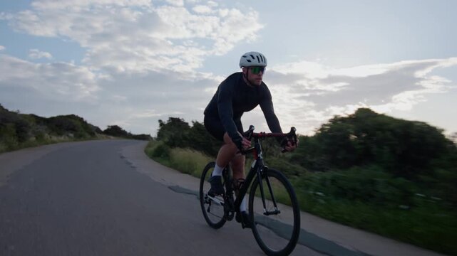 Outdoor cycling training cyclist pedaling bicycle through scenic nature landscape cardio workout fitness sport activity and healthy lifestyle