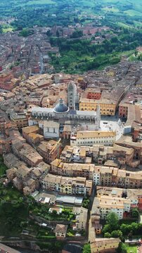 Amazing aerial panorama of historic city of Siena, nestled in the breathtaking Tuscan landscape of Italy, vertical video