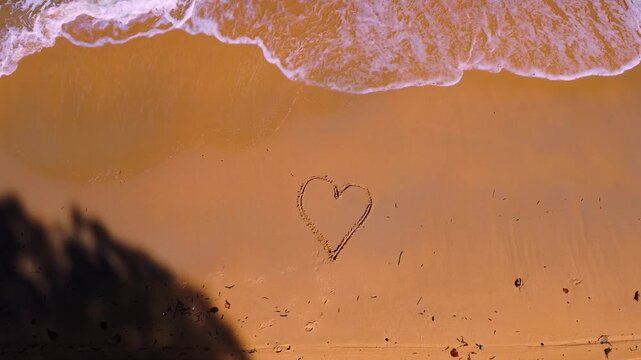 Romantic Heart Drawn in Golden Sand Beach as Ocean Waves Wash Shore: Phu Quoc Vietnam 4K Aerial View