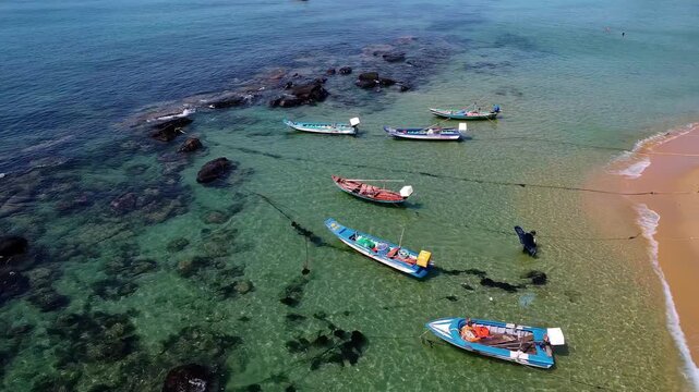 Aerial Top-Down View of Traditional Wooden Fishing Boats in Crystal Clear Water: Phu Quoc Vietnam (4K)