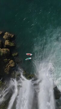 Amazing aerial view of adventure scenery with people paddling under D&uuml;den waterfall