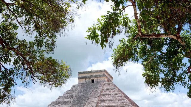 Majestic mayan pyramid of Chichen Itza with trees framing the view