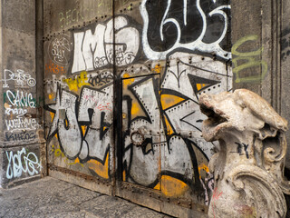 Graffiti-Covered Historic Door and Stone Ornament in Barcelona © James Gu