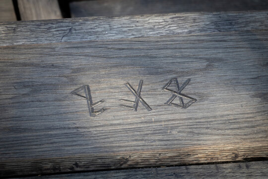 Viking runes engraved in wood