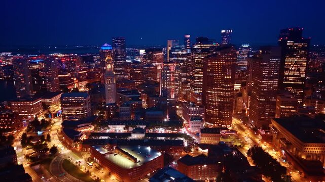 Fantastic city lights of a beautiful modern lively city. Gorgeous buildings with switched on illumination in and well-lit streets of Boston, Massachusetts, USA at night.