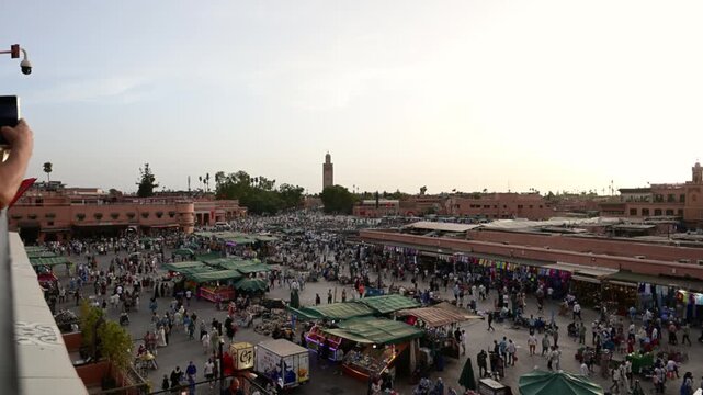 Marrakech, morocco. August 9, 2026. Aerial view of the bustling jemaa el fna square in marrakech. Crowds of people and tourists walking through the market stalls at sunset