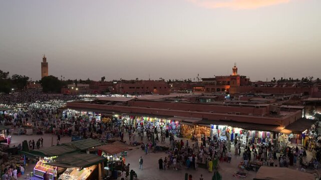 Marrakech, morocco. August 9, 2026. Elevated panoramic view of the bustling djemaa el fna square at sunset. Crowds of people walking through the vibrant night market
