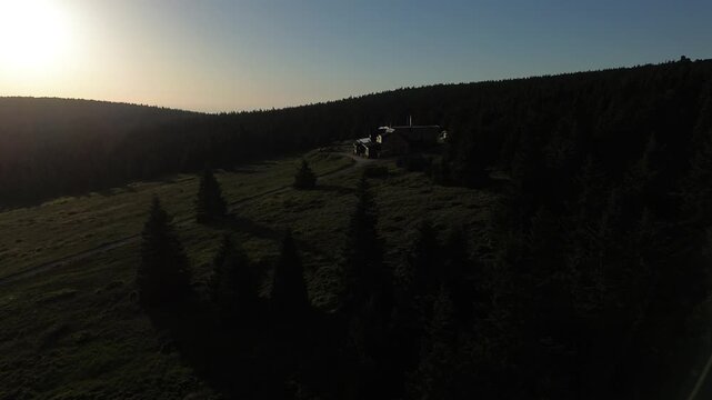 Aerial view of Voseck&aacute; bouda mountain shelter bathed in golden hour light, Karkonosze Mountains