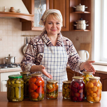 A happy housewife shows off her preparations for the winter