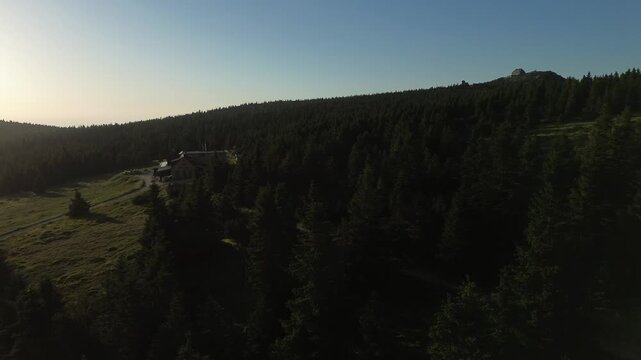 Aerial view of Voseck&aacute; bouda mountain shelter bathed in golden hour light, Karkonosze Mountains