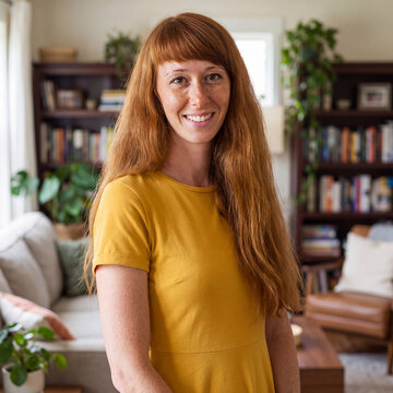 Portrait of a beautiful young red-haired woman at home