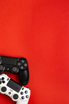 September 4, 2026, Odessa, Ukraine. Sony PS4 DualShock controllers on bright red back