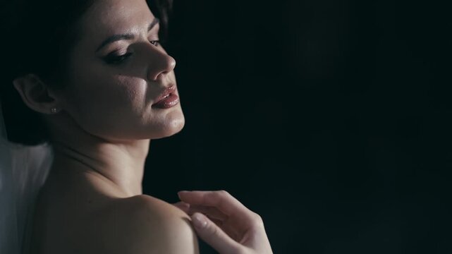 Elegant portrait of sensitive woman touching her body with soft lighting and thoughtful pose