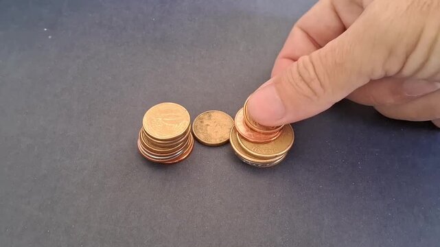 Hand stacking bronze coins