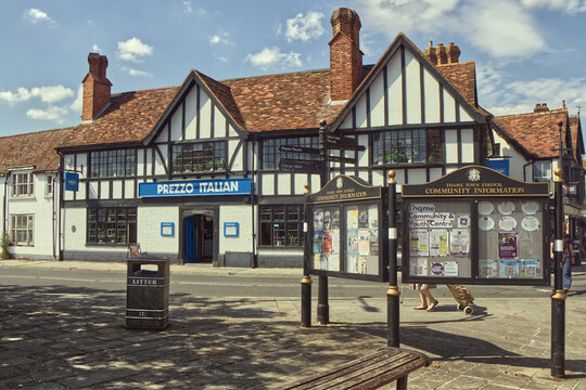 Historic timber-framed Tudor building with exposed black beams and white plaster facade in the town center of Thame, Oxfordshire, England
