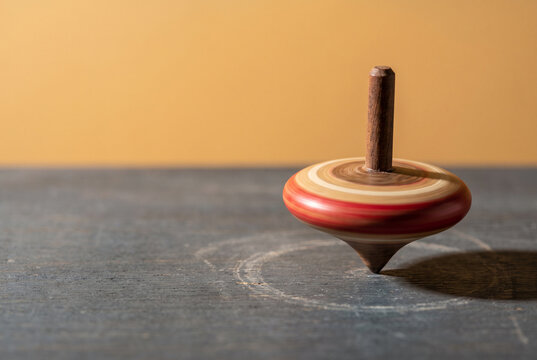 Whirling Wooden Top on Minimal Copy Space Background