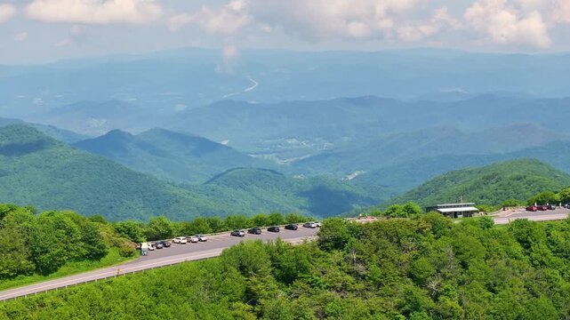 Scenic drive road trip in North Carolina Appalachian mountains. Craggy Gardens overlook car parking area for hikers and travelers.