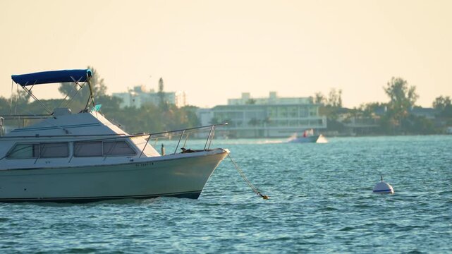 Scenic Sarasota waterfront with luxury boats, calm lagoon waters and bright sunlight at Florida travel destination.
