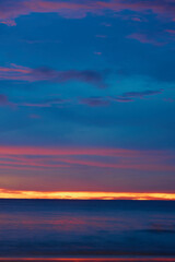 Fototapeta premium Colorful Tropical Sunset Over Calm Ocean with Dramatic Purple and Orange Sky