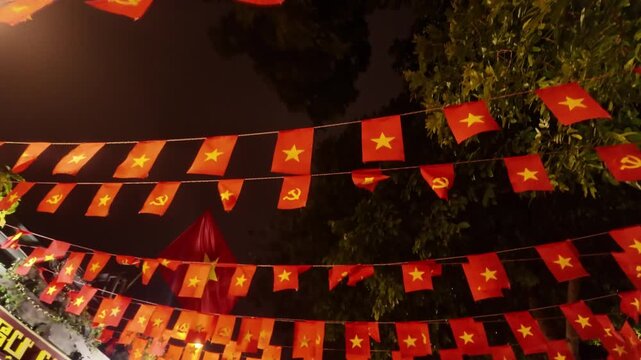 Festive Vietnamese National Flags and Communist Bunting Hanging at Night in Hanoi Old Quarter Vietnam - Stabilized Gimbal Shot Color Graded B-Roll