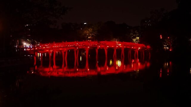 Illuminated Red The Huc Bridge Reflected on Hoan Kiem Lake at Night in Hanoi Vietnam - Stabilized Gimbal Shot Color Graded B-Roll
