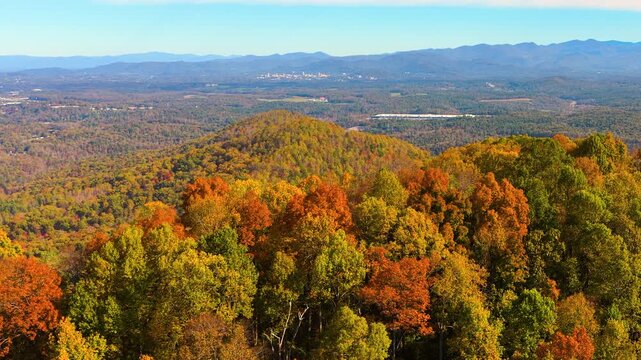 Scenic view of rolling mountain forest filled with vibrant autumn foliage. Dense woodland creates breathtaking landscape of seasonal colors.