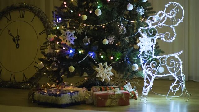 Shiny ornaments and blinking fairy lights on a Christmas tree at night, capturing the warm and joyful atmosphere of the holiday season.