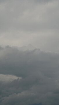 timelapse of dark stratus clouds moving rapidly above a layer of denser storm clouds