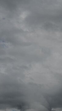 timelapse of continuous gray cloud cover with rare gaps filling the entire overcast sky
