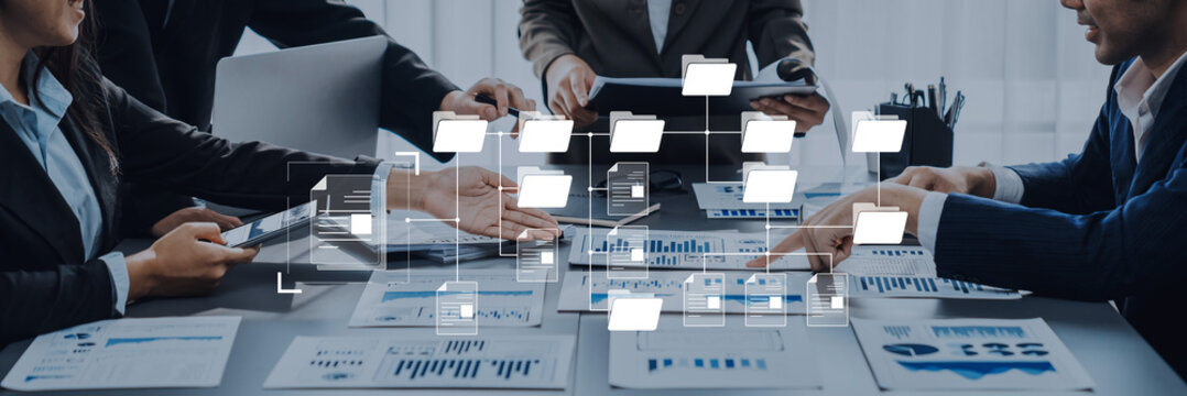 A group of professionals engages in an interactive business meeting, utilizing technology and data analysis to drive project ideas and strategic planning. Trope