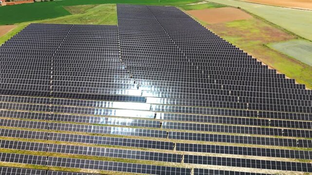 Drone closing in on sunlit photovoltaic array in Avila Spain